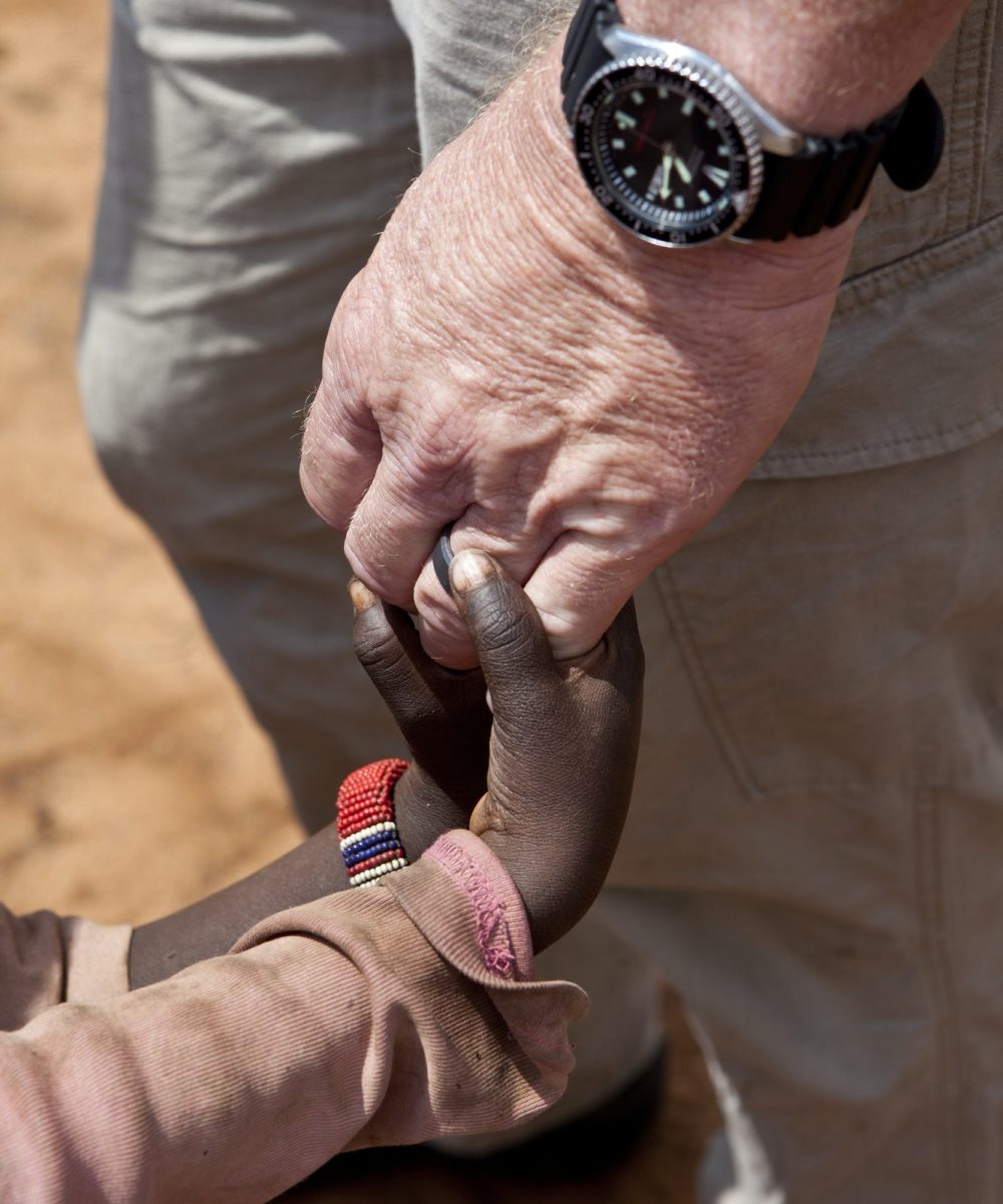 aid-worker-s-hands-holding-children-s-hands.jpg